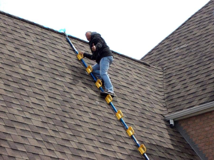 Worker Using Goat Steep Assist on shingle roof - Image Courtesy of Solar Tools USA