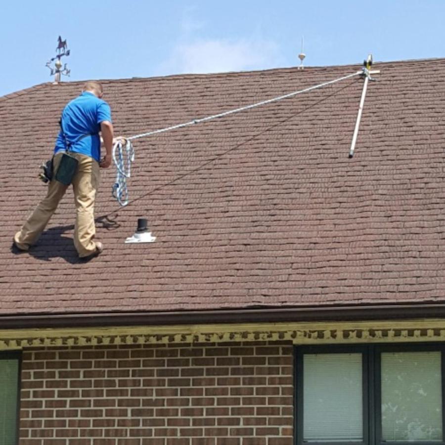 Worker using the RidgePro to move around safely on a shingle roof