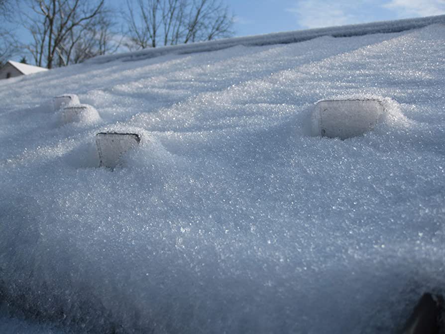 Image showing polycarbonate snow guards holding snow field on roof