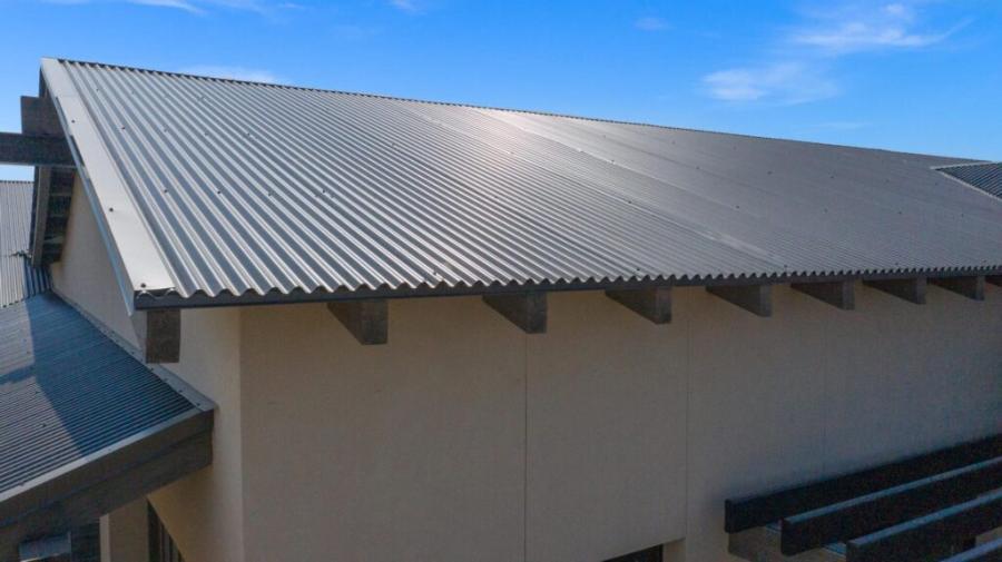 Coated Metals Group Exposed Fastener Roof Installed - Image courtesy of https://www.cmgmetals.com/