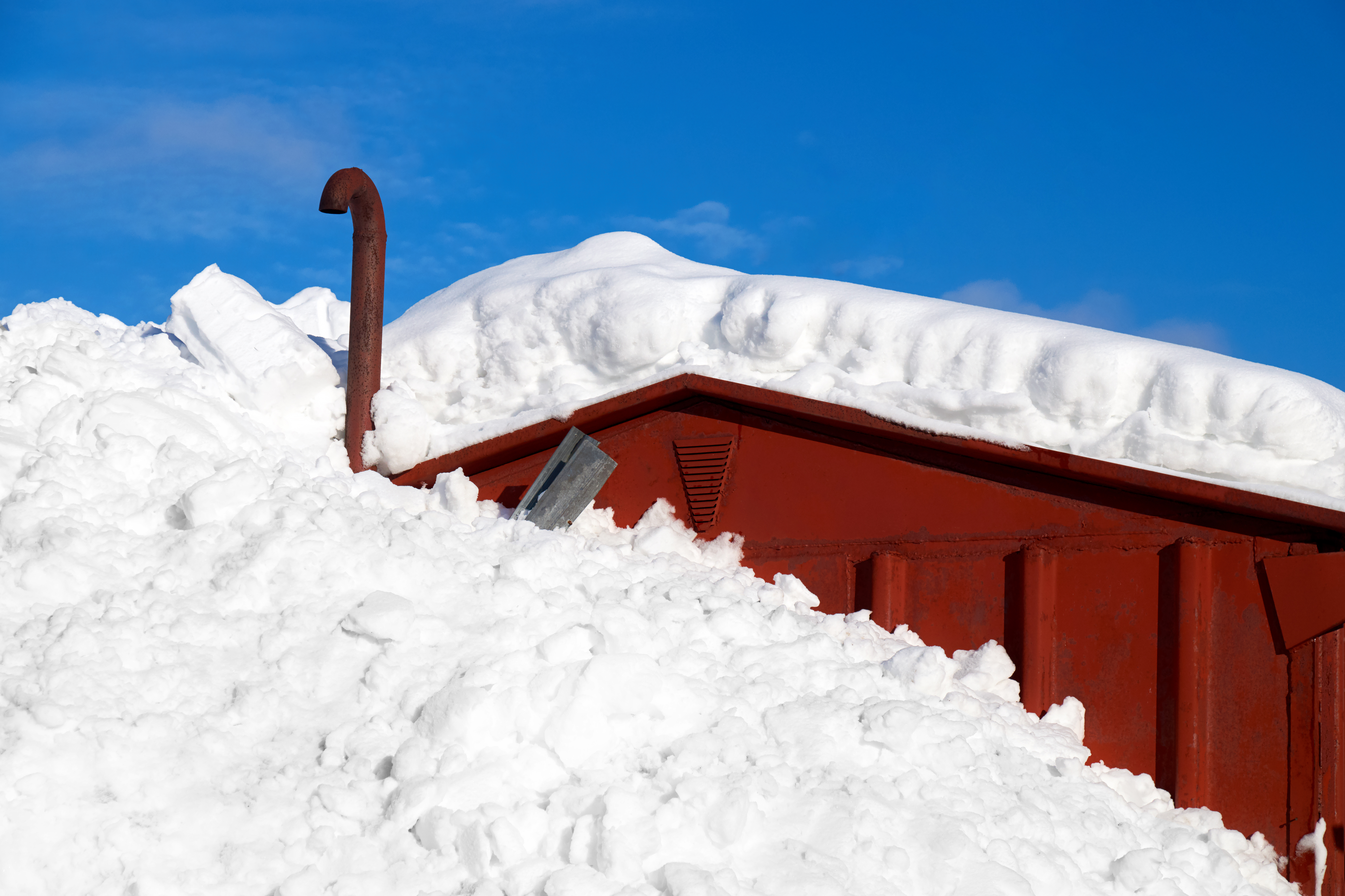 Image showing extreme snow fall on roof and beside building