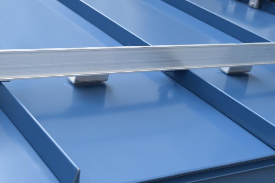 Mill finish aluminum ColorBar with IceStopper Attachments on Blue Standing Seam Roof