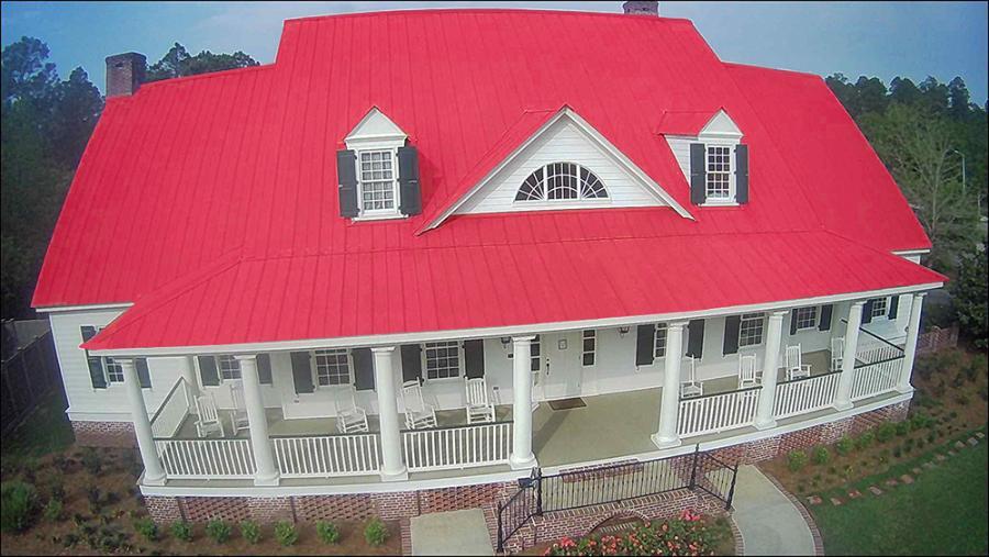 Goldin Metals red roof installed on residence - Image courtesy of https://www.goldinmetals.com/