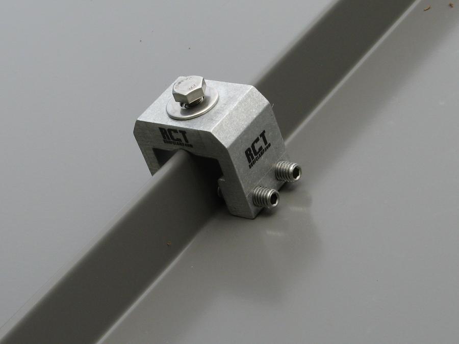 An image of a RoofClamp RCT mounted on a standing seam metal roof panel.