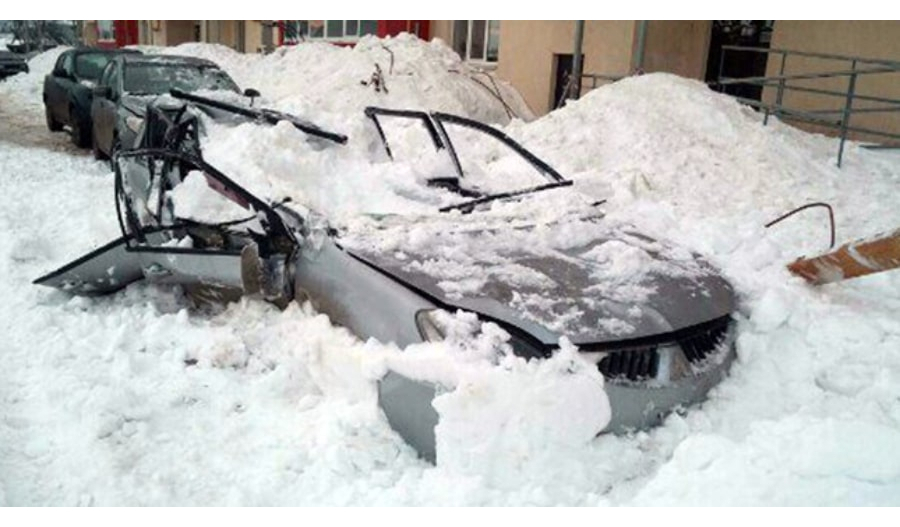 A Mitsubishi Lancer Crushed By Avalanching Snow and Ice From a Roof (Image Courtesy of CarScoops.com)