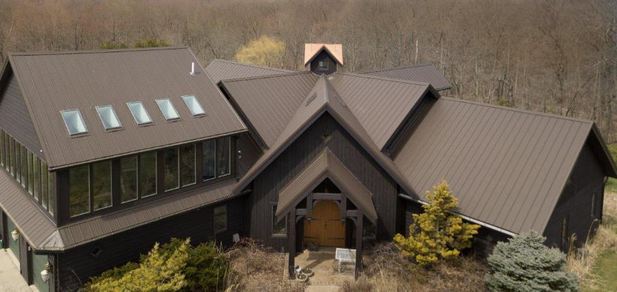 Metal Exterior Brown Roof Installed Elite Rib - Image courtesy of https://metalexteriors.com/