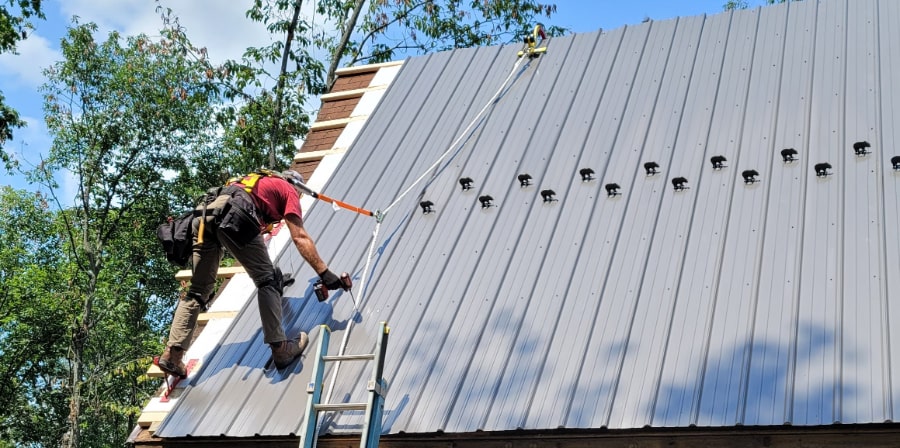 Image of a roofer installing Kodiak SnowCatchers while using a RidgePro