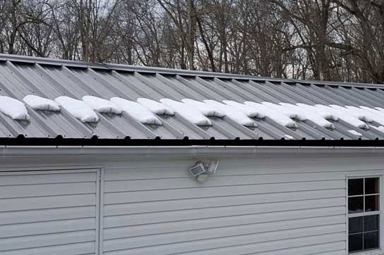 IMage showing snow guards holding snow on screw down roof