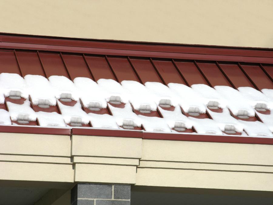 Local grocery store with Snojax II mounted on their awnings to protect pedestrian walkways